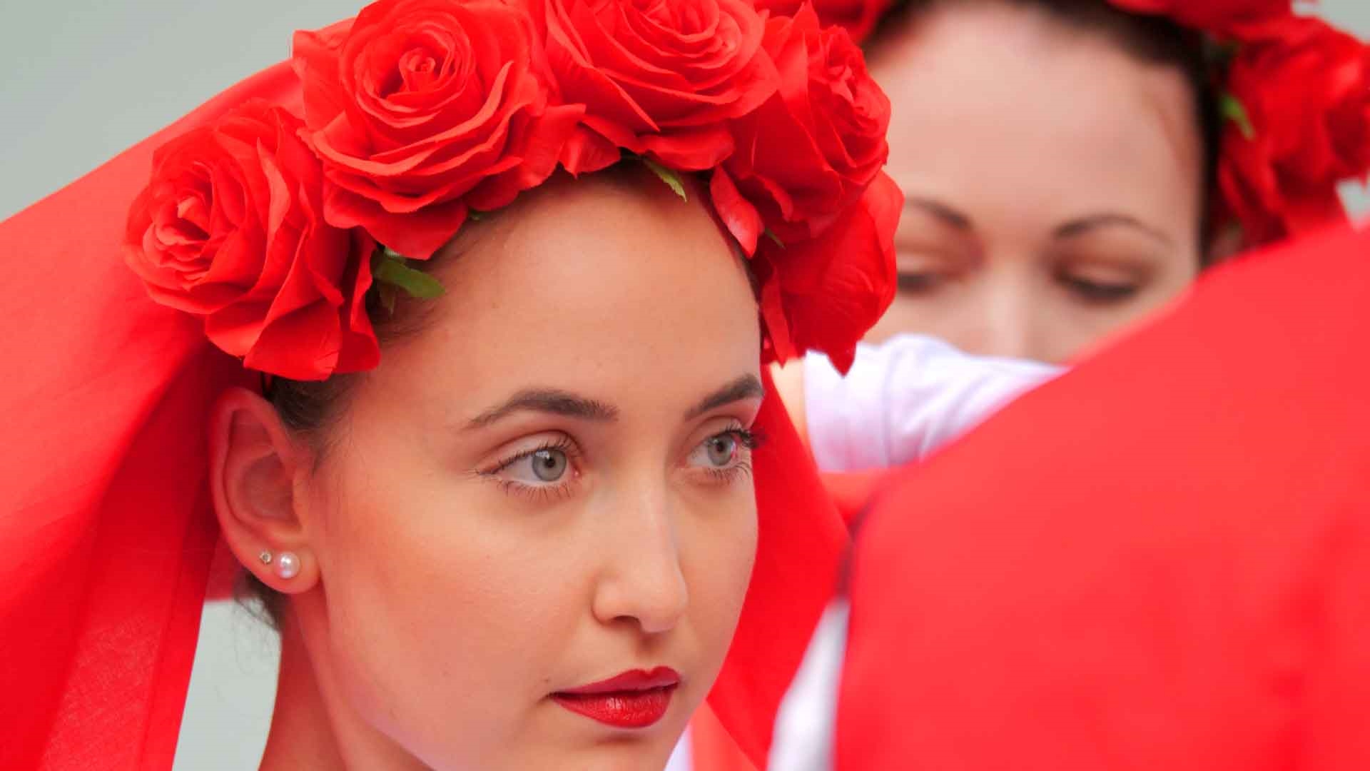 Closeup of students wearing traditional Bulgarian clothing taking part in a performance.