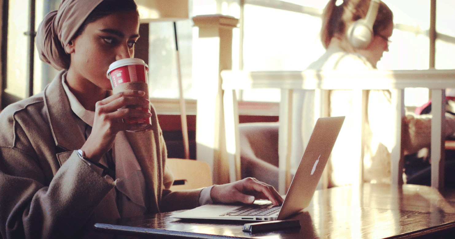 Girl with coffee and laptop in Recharge