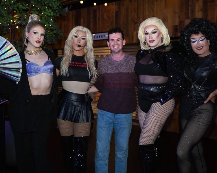 Union President with drag queens at their show.