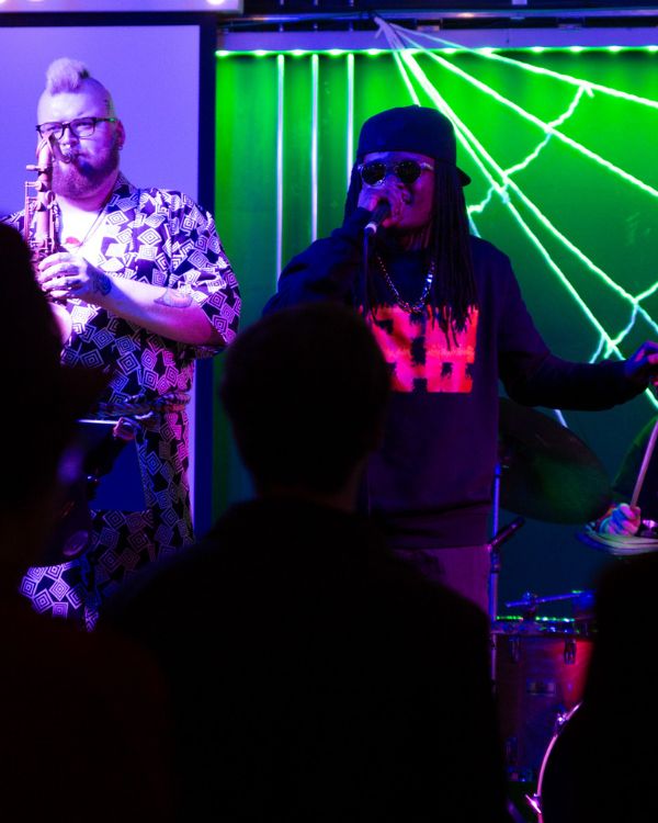 Singer and saxophone player on stage.