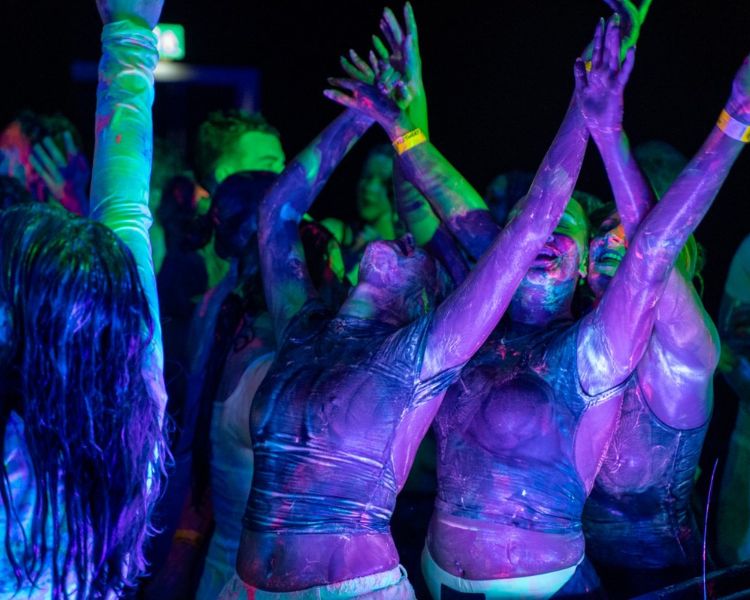 Students dancing at paint party.