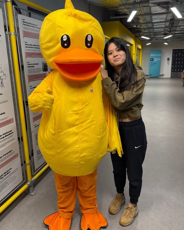 Student with duck mascot.