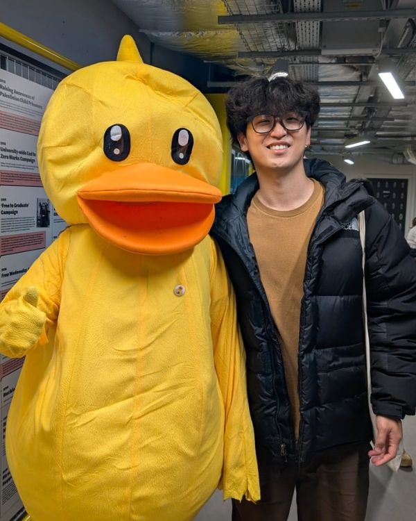 Student with duck mascot.