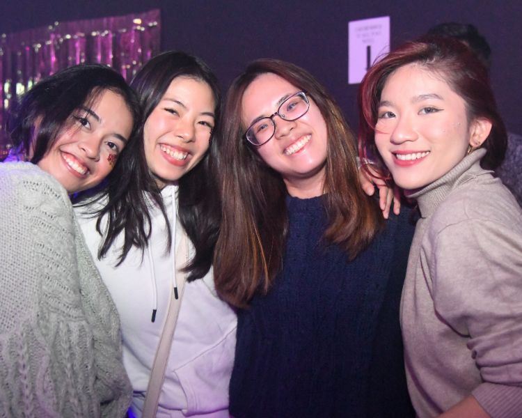 Four students posing together in The Venue.