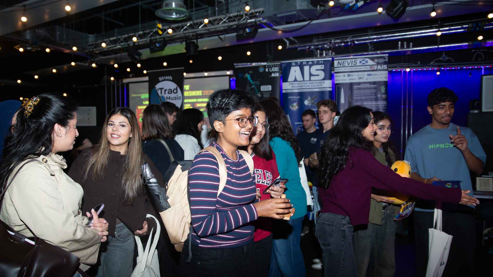 Students interacting with various Societies' stalls.