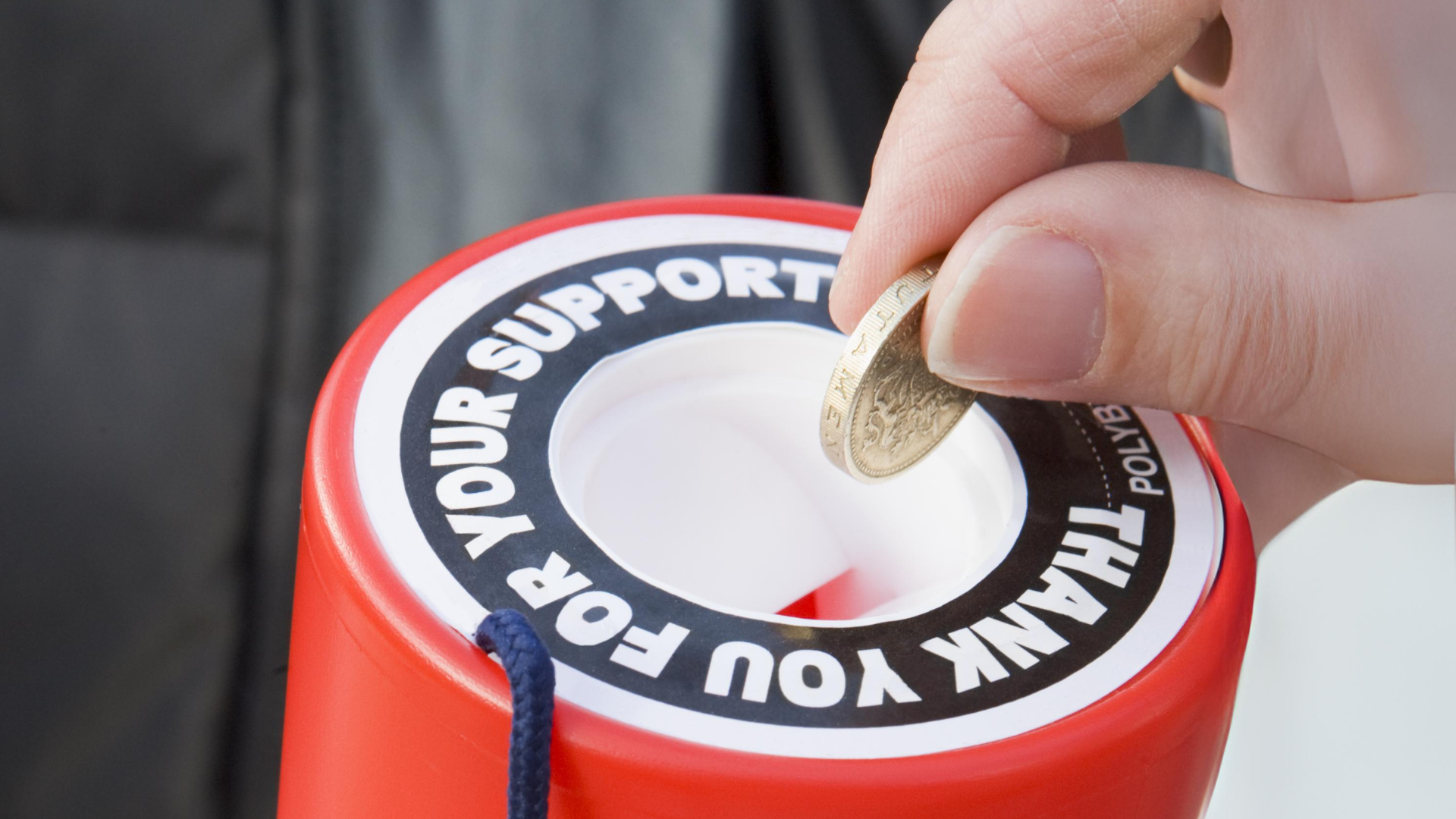 Blue hand held charity collection box.