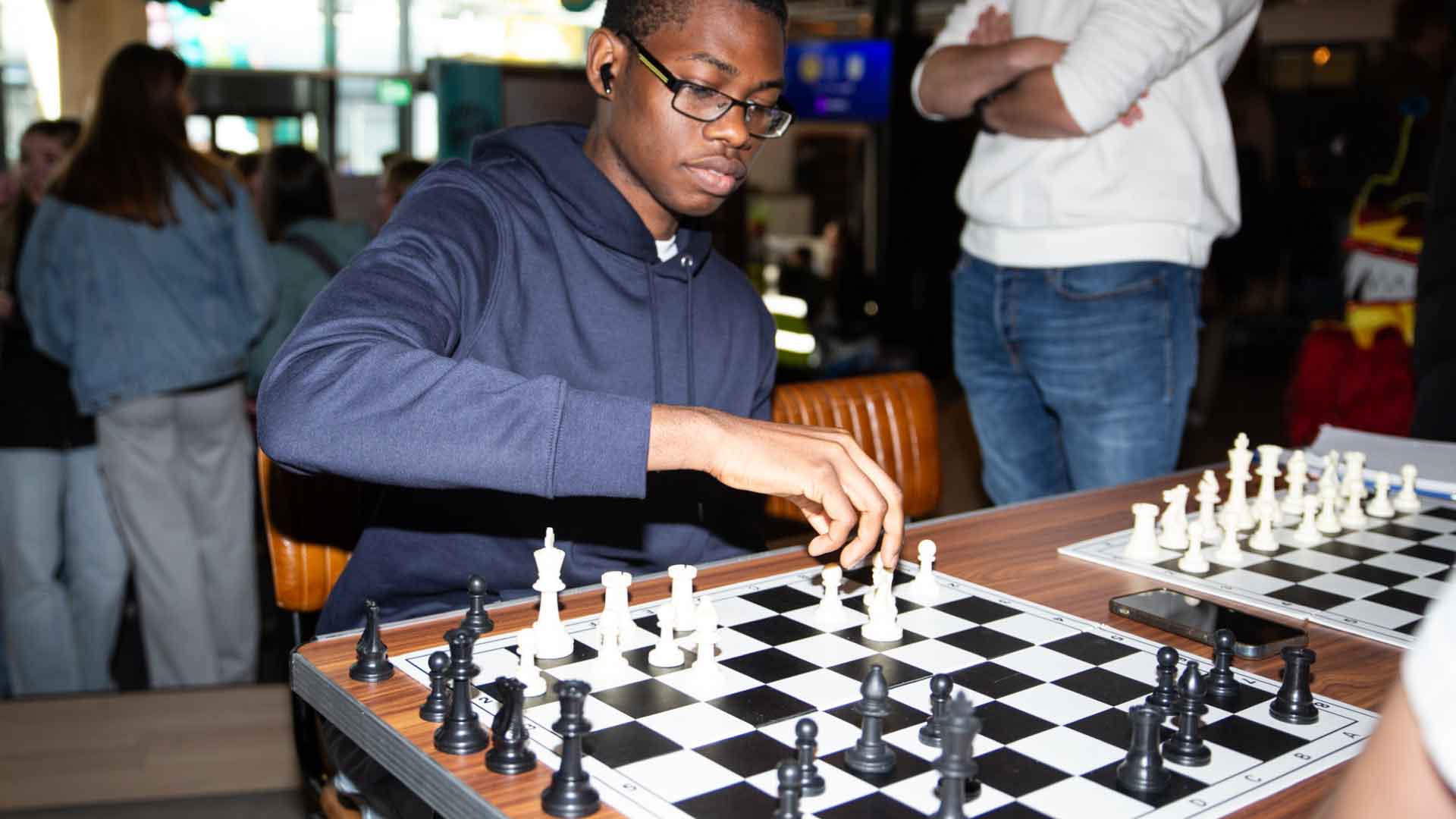 Student playing chess in Strath Union