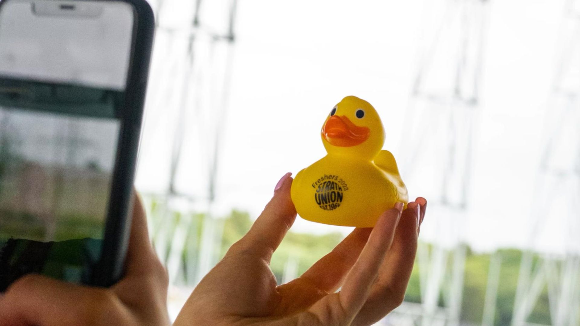 Hand holding Union branded duck to take a photo