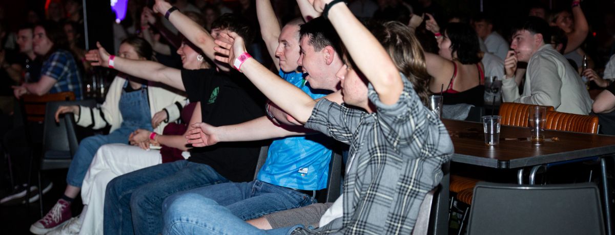 Students raising their hands during karaoke