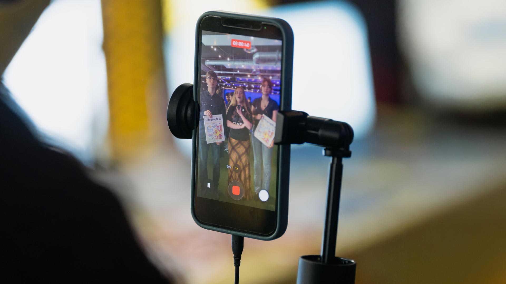 Phone on stand, filming members of the Strathclyde Telegraph newspaper.