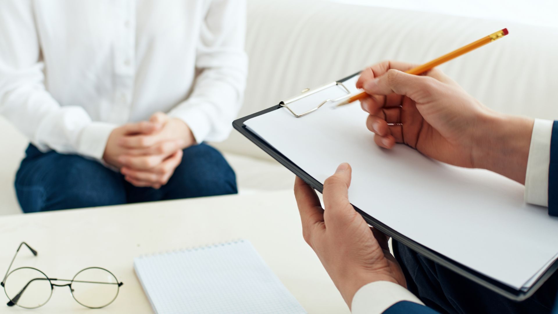 Person writing on clipboard