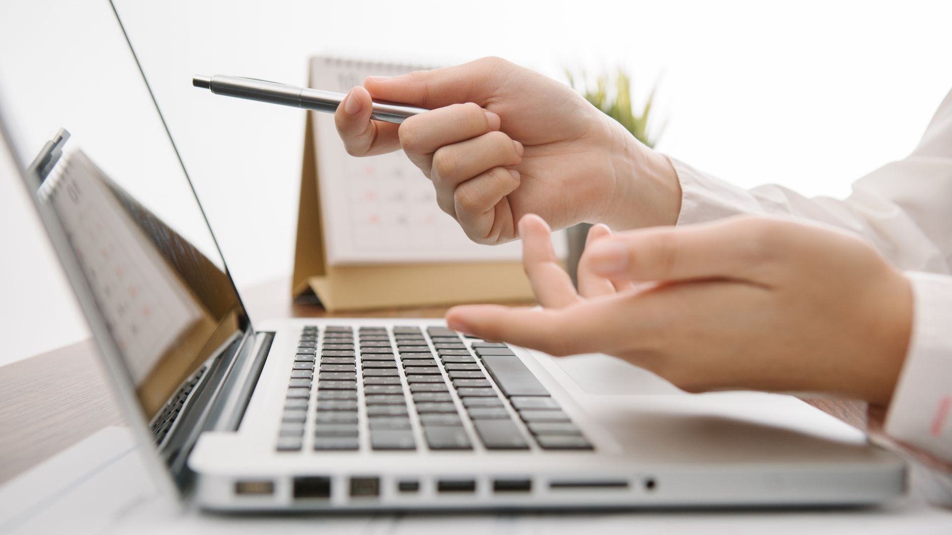 Person pointing at laptop