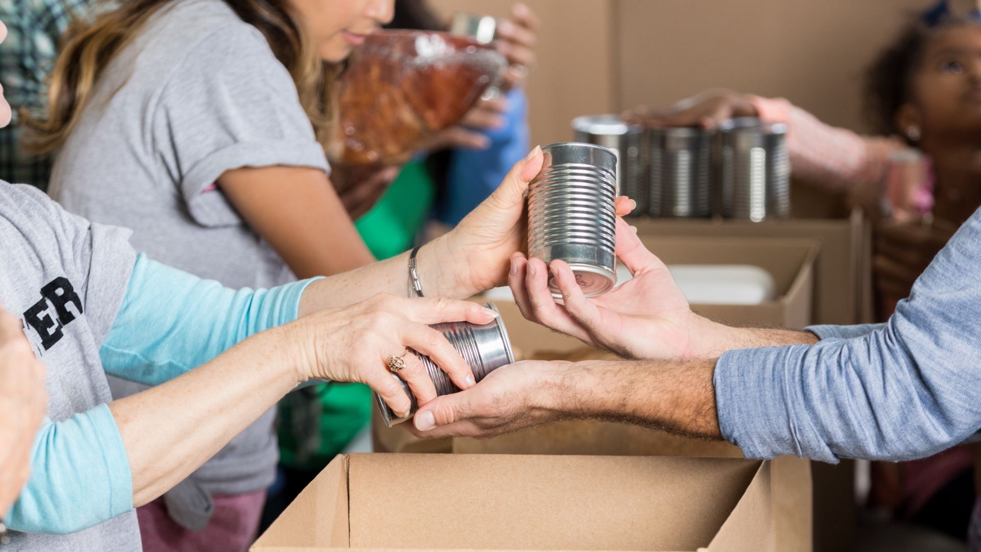 Volunteers organising donated items into boxes