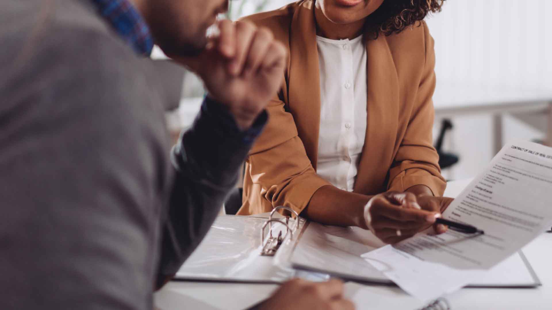 People talking and looking over documents