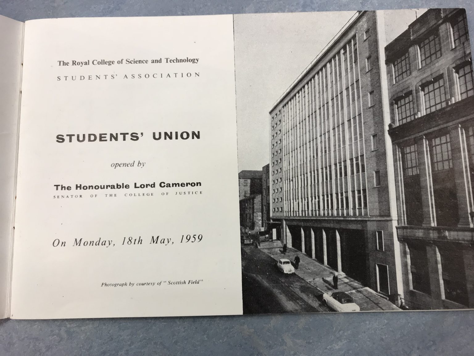 A photograph of an aged printed booklet that reads 'Students' Union opened by The Honourable Lord Cameron on Monday 18 May 1959