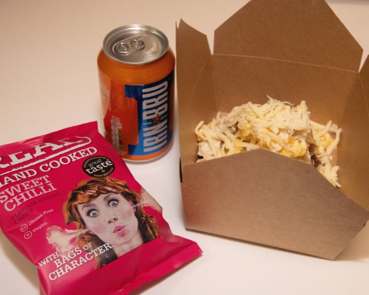 Baked potato meal deal with can of juice and crisps.