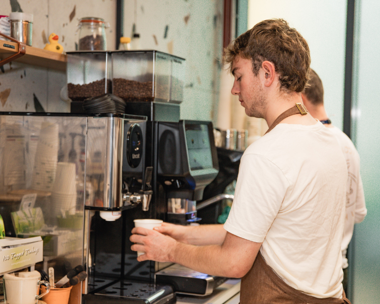 A. member of Roasters staff making coffee