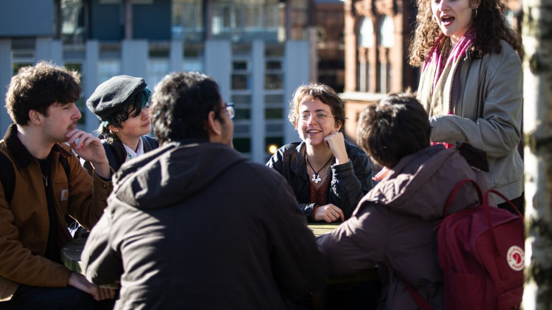 Group of students sitting together in Rottenrow Gardens.