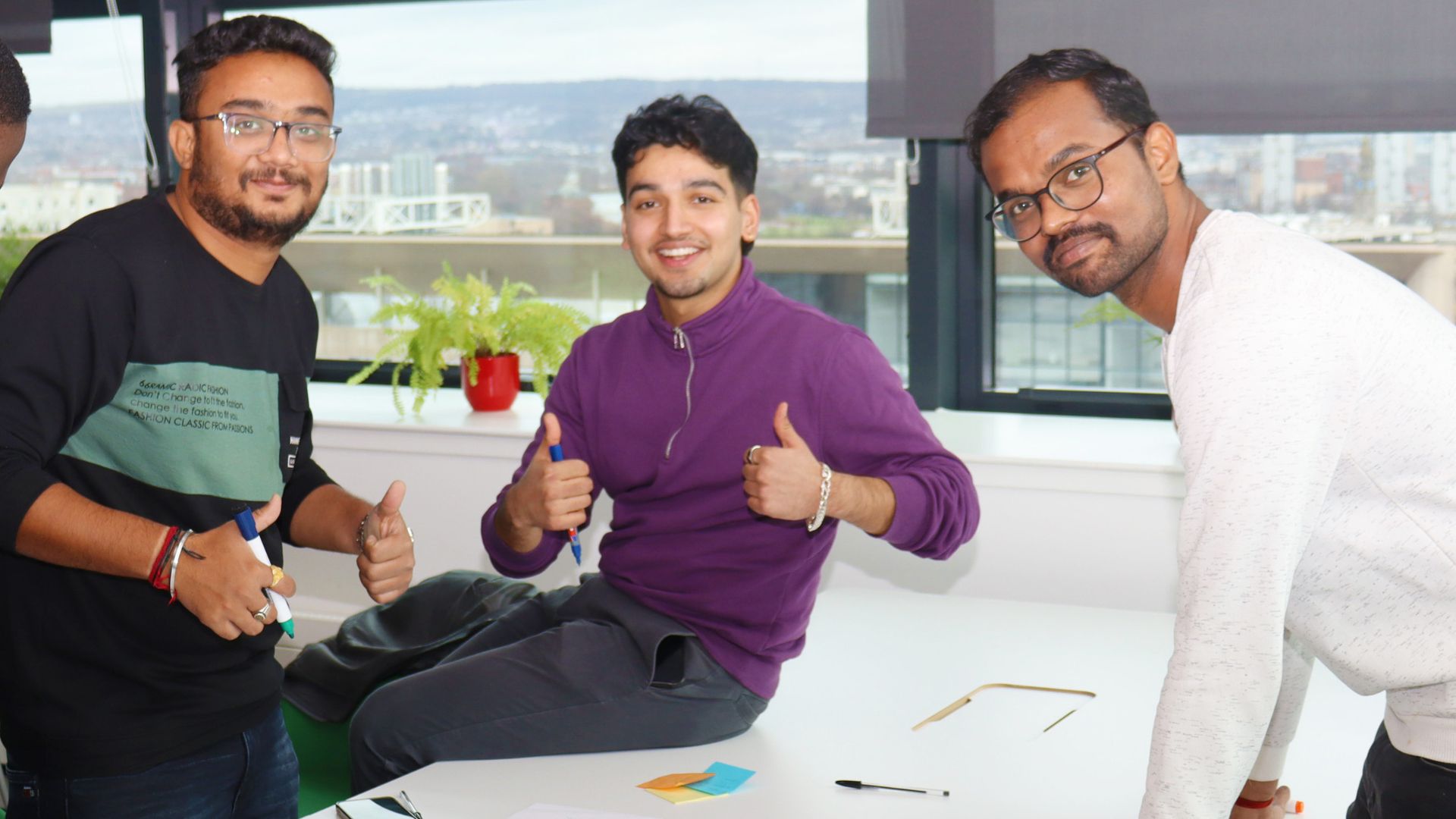 Three students working in a group on a project.
