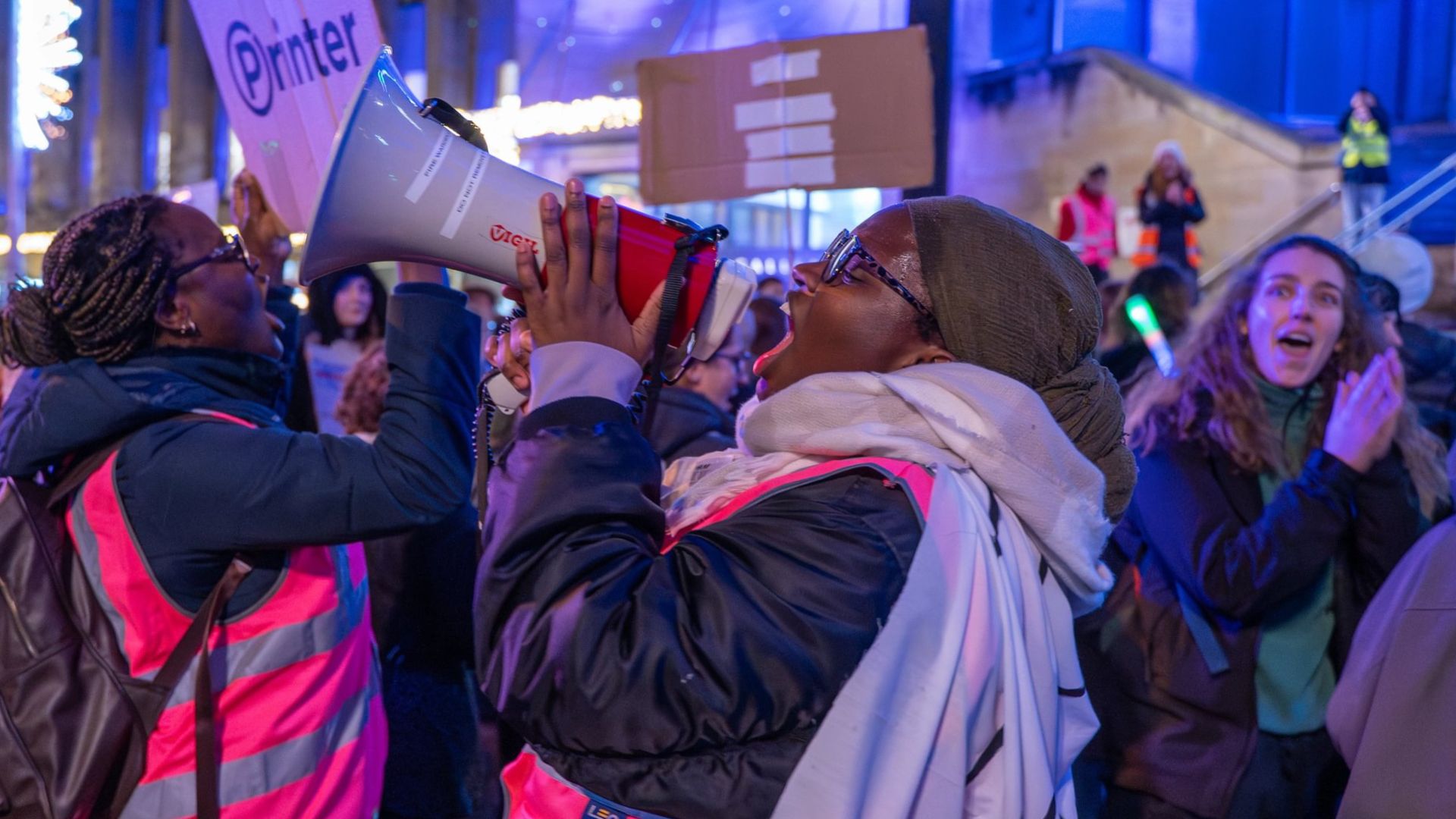 Student using megaphone at Fight for the Night march during rally at Buchanan Street Steps.