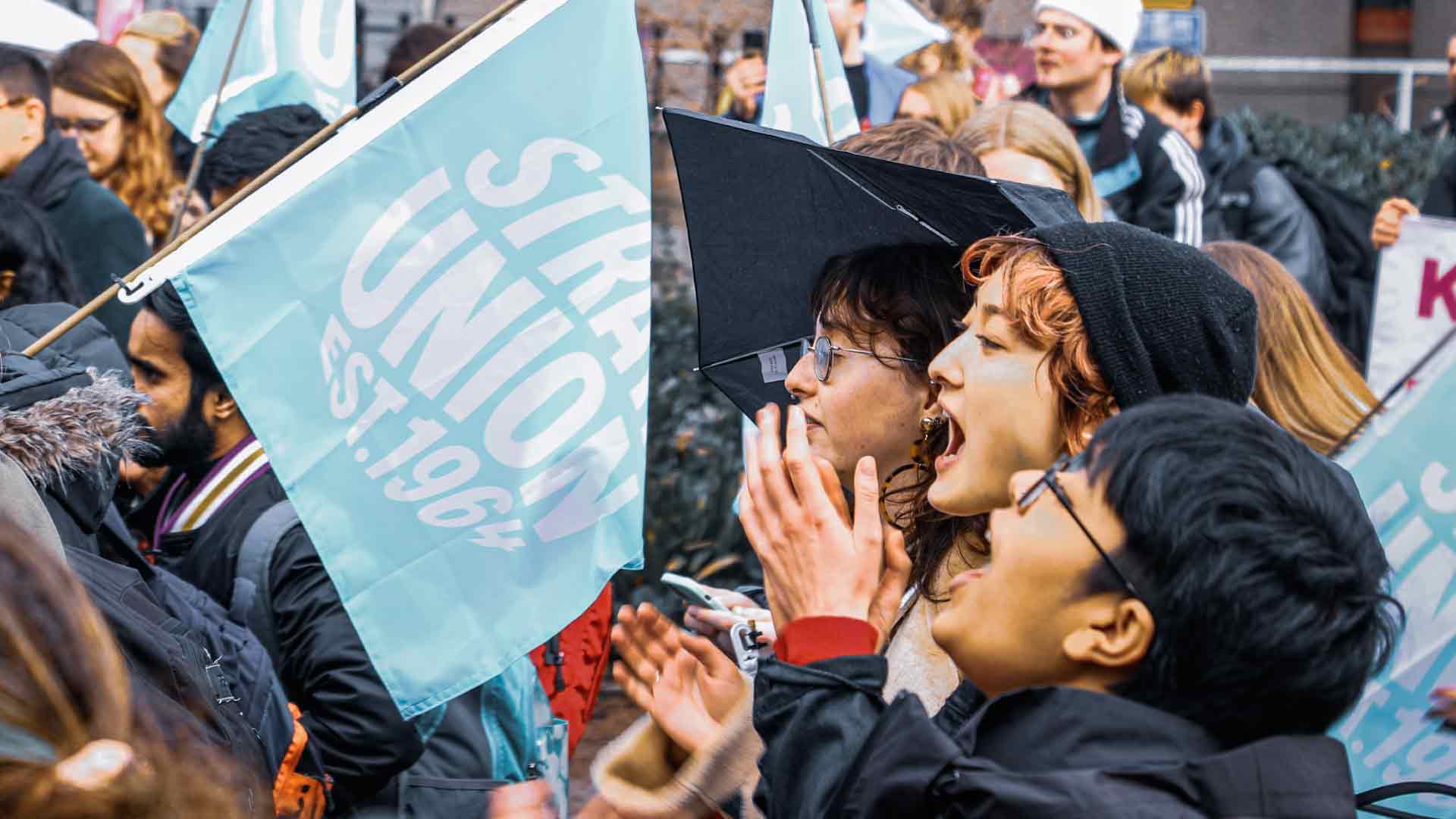 Strathclyde students campaigning, holing Strath Union flag.