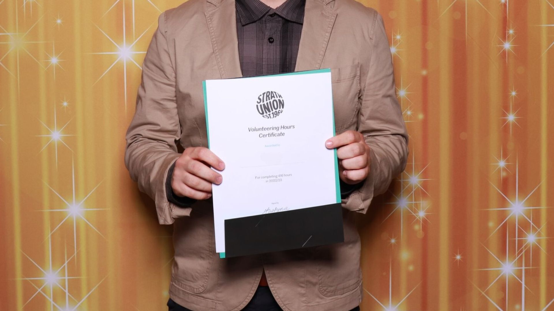 Student holding certificate